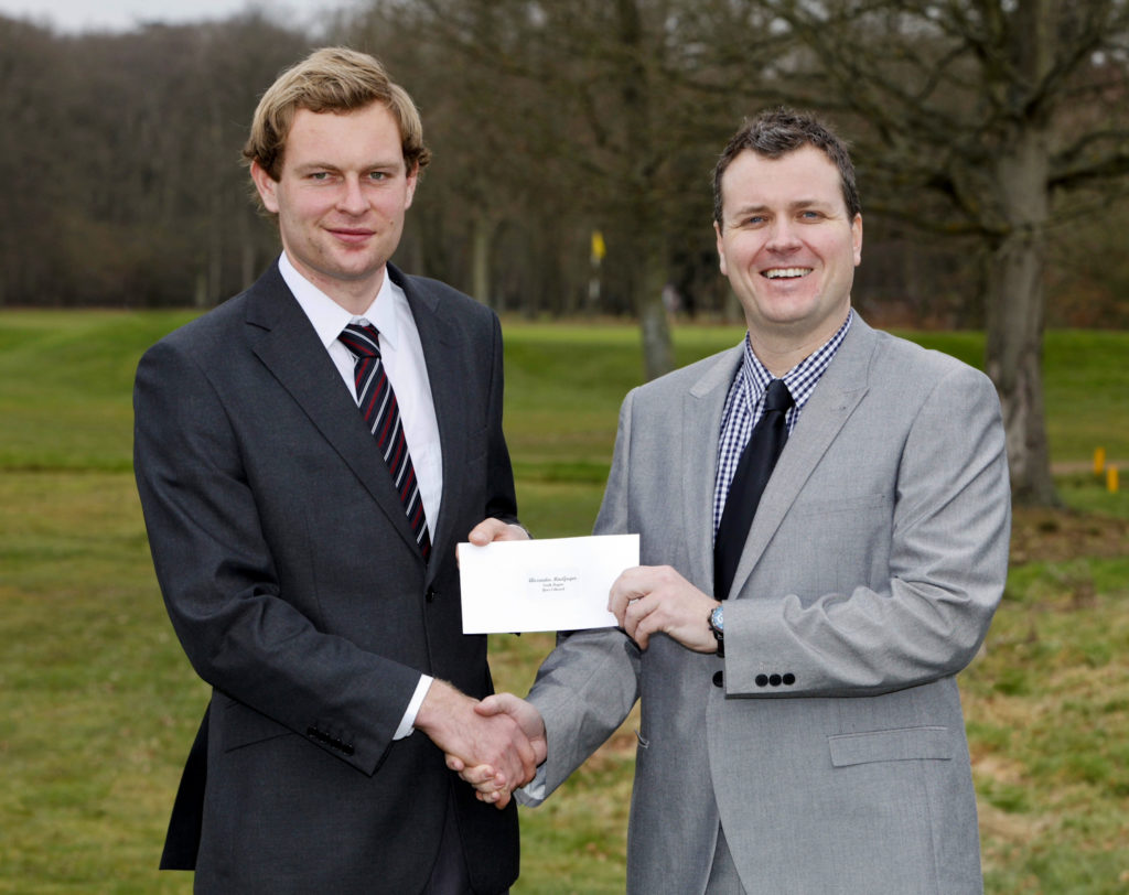 Alex MacGregor of Addington Court GC, “PGA South Region Year 2 Trainee of the Year 2012” (l) being presented with his cheque by a representative of TGI Golf Partnership, sponsors of the PGA Trainee Awards.