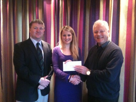 Jeannie Pitt, the local Cancer Research UK area organiser, receives her cheque from Bob Cooper