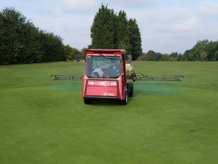 Lee Sayers Course Manager of Mid Kent Golf Club spraying Tricure on the 15th green