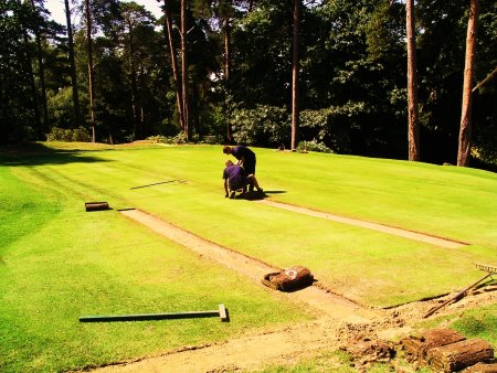 Foxhills greenkeepers relaying turf on the drains on the 9th Green