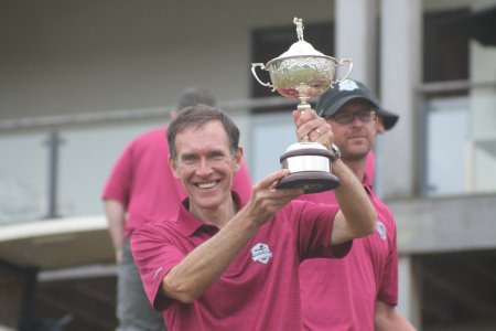 TGI Golf Captain Peter Hanna holds the Ashworth Cup aloft