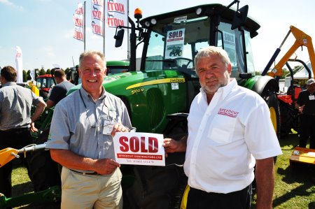 Speedcut Contractors md Dick Franklin (right) with Peter Helps of Farol Ltd and the new John Deere 5100M purchased on the Farol stand at SALTEX 2013