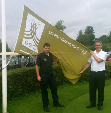 Redbourn Course Manager, Haydn Drinkwater (left) holds aloft the GEO flag with General Manager, Ian McDowell
