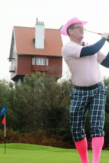 Stephen Cordory, Operations Manager, Thorpeness Hotel and Golf Club, tees off in front of Suffolk’s iconic House in the Clouds during the Thorpeness Pink Putter