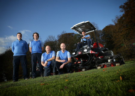 Course manager Jaime Acton seated on the Toro Groundsmaster 4500-D, and the greenkeeping team