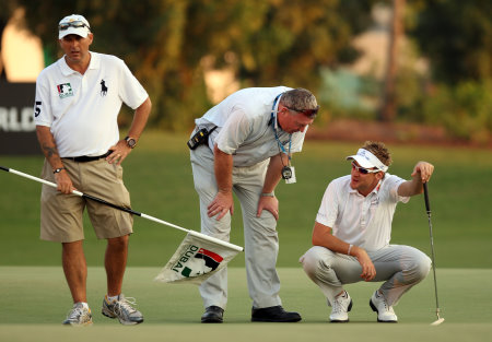 Ian Poulter pictured with Senior Referee, European Tour, Andy McFee, when The Ryder Cup star incurred a penalty shot during the second play-off hole at the 2010 DP World Tour Championship on the Earth Course at Jumeirah Golf Estates, after he dropped his ball on his marker