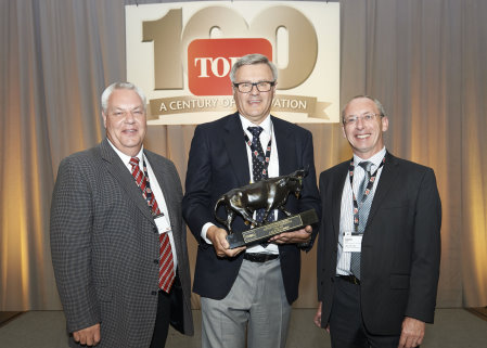 Graham Dale, Lely's managing director, accepts The Toro Company's annual Distributor of Excellence Award with Trevor Chard, Lely key account manager, on his left and David Cole, Lely turf division senior manager