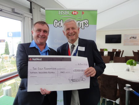 Nigel Freemantle (left), Chairman of the BGIA, presents a cheque for £15,000 from the BGIA's charity golf day and the 'Grow Golf' fund, to Charles Harrison, Chairman of the Golf Foundation, during the SMS INC. industry lunch at Royal Liverpool