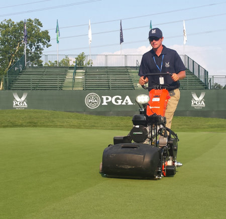 A Valhalla grounds crew member mows the 8th green with a Jacobsen ECLIPSE walking greens mower during the PGA Championship