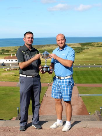 Keighley Golf Club’s Liam Blacka (right) with the club’s PGA Professional Andy Rhodes, hold aloft the TaylorMade-adidas Amateur Championship trophy on the steps of the famous Turnberry hotel