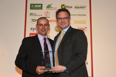 Edward Ainsworth (left) collects his award from Nick Brown of Ransomes Jacobsen