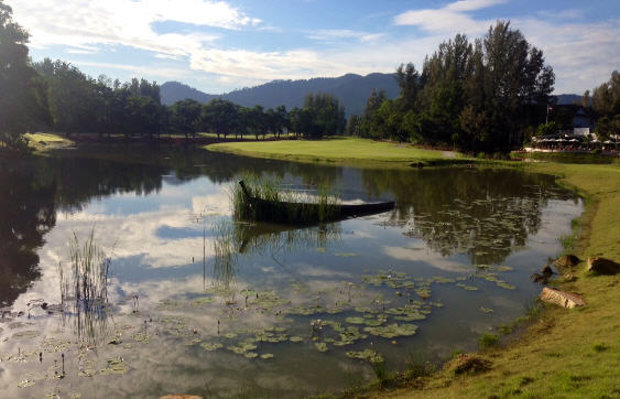 A traditional Thai fishing boat in the water course beside the 7th hole;