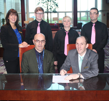 Bryan McCabe, foreground left, signs the agreement with Franck Bruyere, director of food and beverage at Fairmont St Andrews, watched by (l-r) the resort’s human resources manager, Carol-Ann Hibbert, and students Josh Ford, Lynne Gilfillan and Keith Wallace