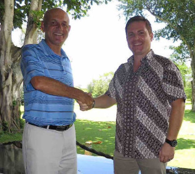 Mark Siegel (left) and Renato Domini shake hands on their new partnership
