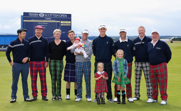 GULLANE, SCOTLAND - JULY 08: (L-R) Actor Dougray Scott, Rugby Player Gavin Hastings, Mindroom Charity Founder Sophie Dow, Chris McGregor and 8-month-old daughter Eloise (third place) held by Marc Warren of Scotland, Justin Rose of England, Ryan Palmer of the United States, Comedian Rory Bremner, CEO of Aberdeen Asset Management Martin Gilbert, 3-year-old Jessica Donaldson (first place, front L) of Pencaitland and 8-year-old Emma Rule (second place, front R) of Paisley pose for a photo during Tartan Wednesday prior to the start of the Aberdeen Asset Management Scottish Open at Gullane Golf Club on July 8, 2015 in Aberdeen, Scotland.  (Photo by Jan Kruger/Getty Images)