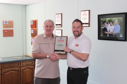  Topturf Irrigation MD Colin Clarke on the left is presented his award by Roger Lupton, Lely’s former Otterbine sales manager