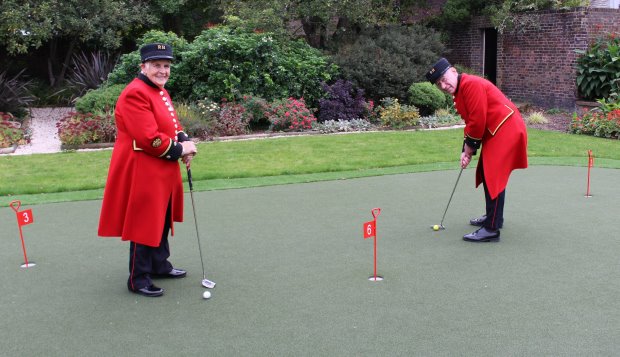 Chelsea Pensioners Audrey Merton and Douggie Payne enjoy their new Huxley Golf putting green
