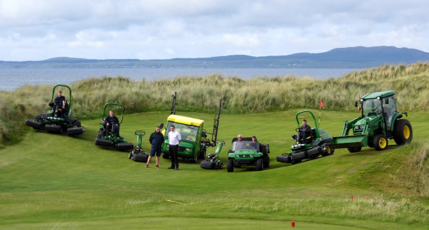 Machrie Golf Links course manager Dean Muir with Nairn Brown Ltd sales manager Andy Gillies (standing left & right), with the greenkeeping staff and a selection of their new John Deere machines