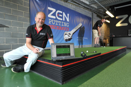 Nick Middleton, Managing Director of Zen Oracle, tests his robotic putting green