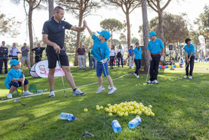 Sergio Garcia shares a high five at one of his Junior Academy events