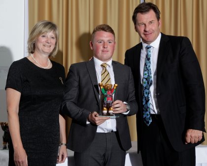 Reigning Faldo Series Grand Final - Boys’ Under-21 Champion Jack Yule (centre) with Alison White, Assistant Director of Golf Development at The R&A (left) and Sir Nick Faldo (right)