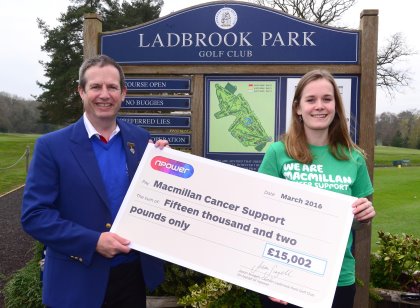 npower's Jason Scagell presents Elisa Beeley from Macmillan a cheque for.£15,002