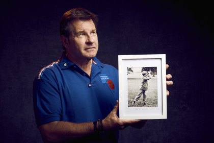 Sir Nick Faldo with a portrait of Albert Tingey, a founding member of The PGA who founded the Niblick Brigade which fought in the Great War (image courtesy of the Royal British Legion) © Mikael Buck / Royal British Legion