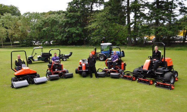 Stuart McBain (centre) with a few team members and a selection of recently purchased machinery from Jacobsen