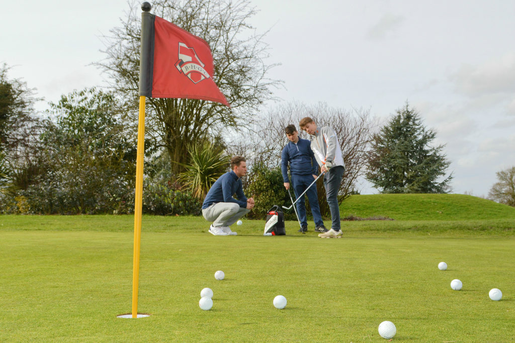 (from left) James Weekley, Ben Flint and a junior golfer during a coaching session at Broke Hill Golf Club