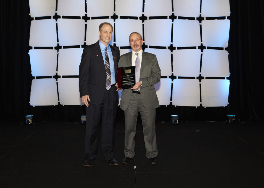 Reesink Turfcare managing director David Cole, right, collects the outstanding performance award from Toro’s Brad Nagel